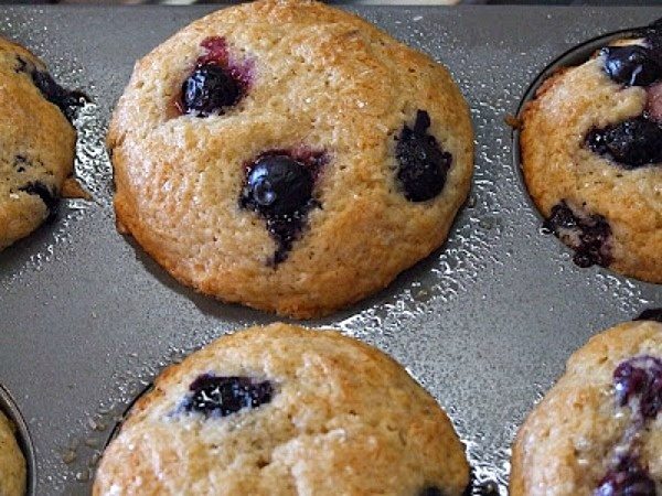 blueberry maple muffins in a muffin pan
