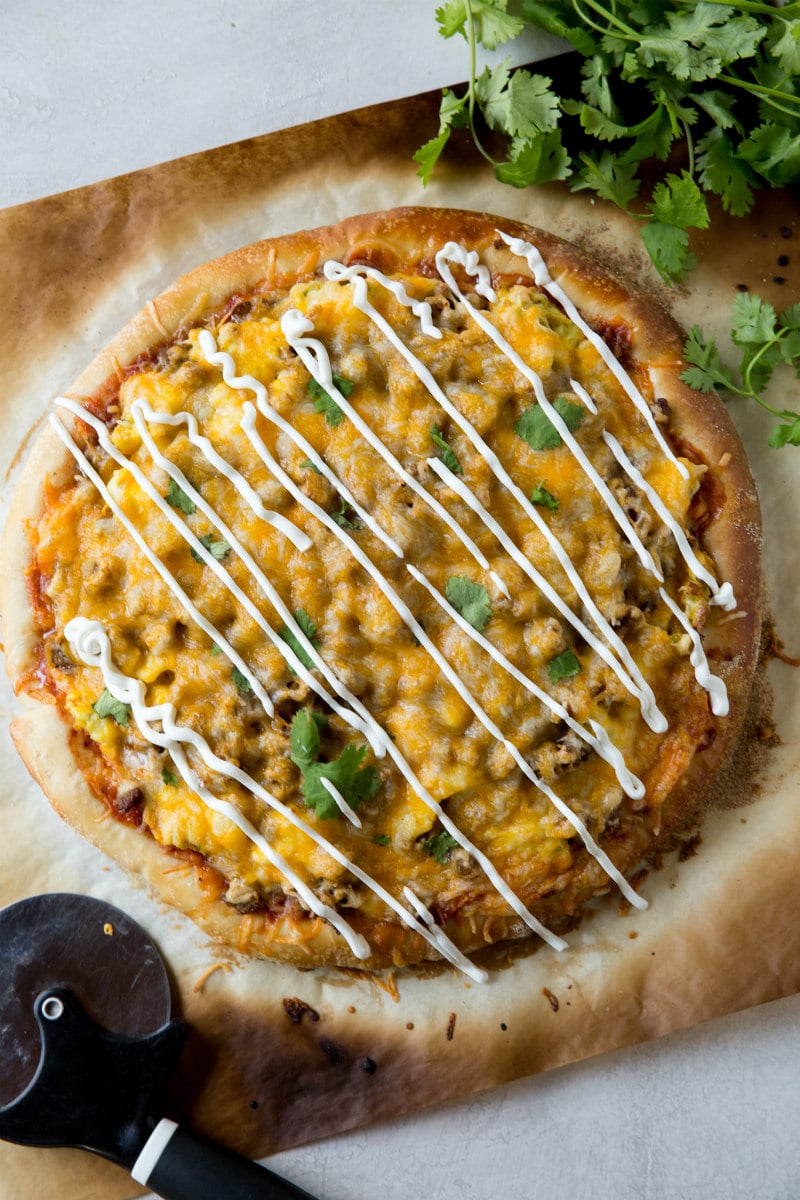 Sausage and Scrambled Egg Pizza topped with sour cream