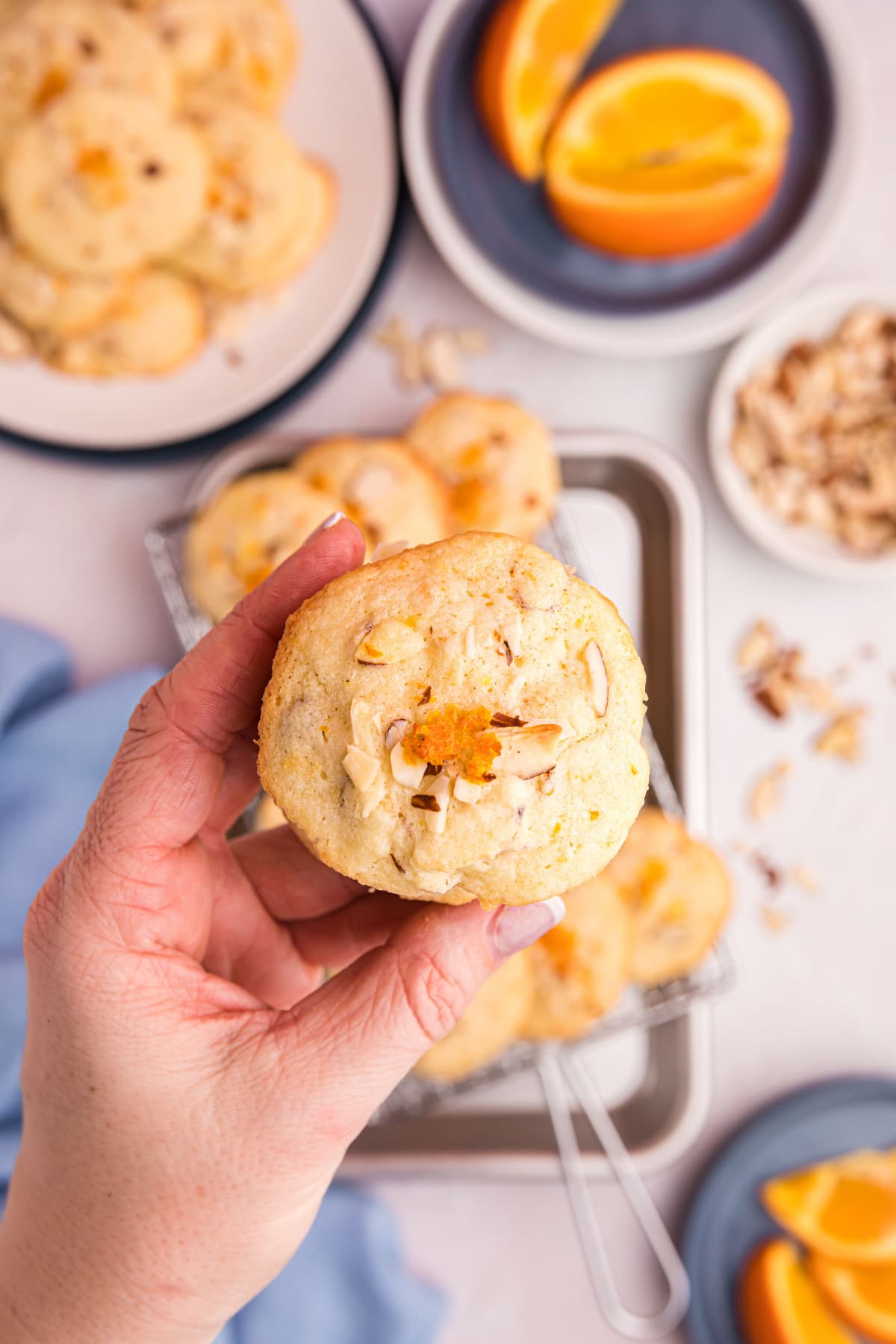 hand holding almond orange wafer cookie