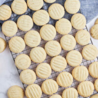 many sugar cookies on a baking rack