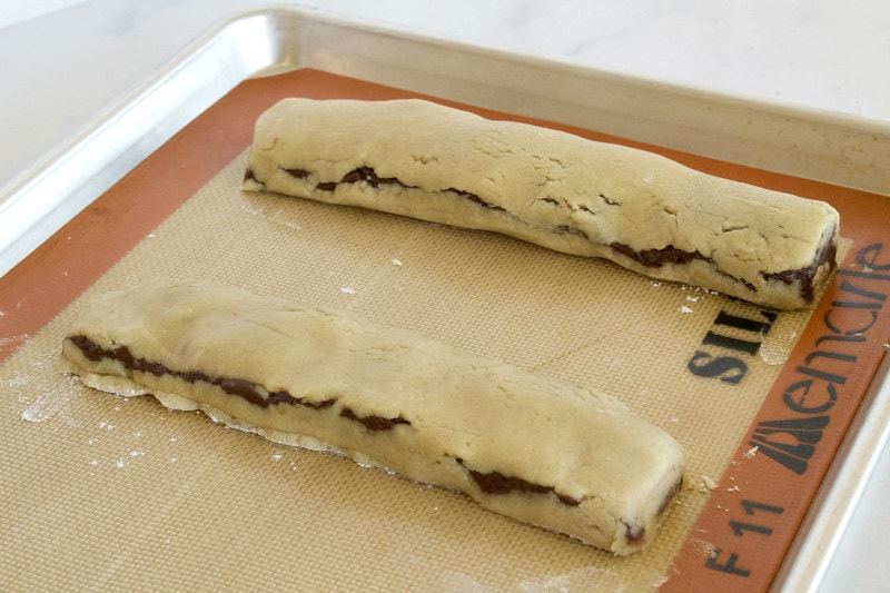 two bake and slice chocolate swirl cookie bars on a baking sheet ready for the oven