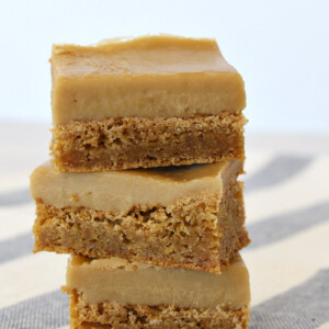 stack of 3 butterscotch brownies sitting on a blue and white striped cloth towel