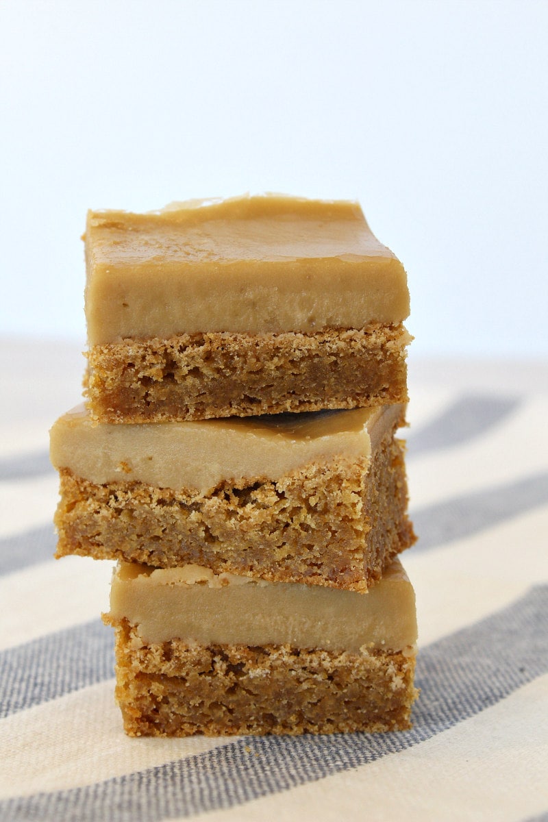 stack of 3 butterscotch brownies sitting on a blue and white striped cloth towel