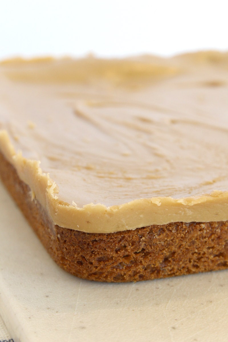 slab of butterscotch brownies on a cutting board waiting to be cut