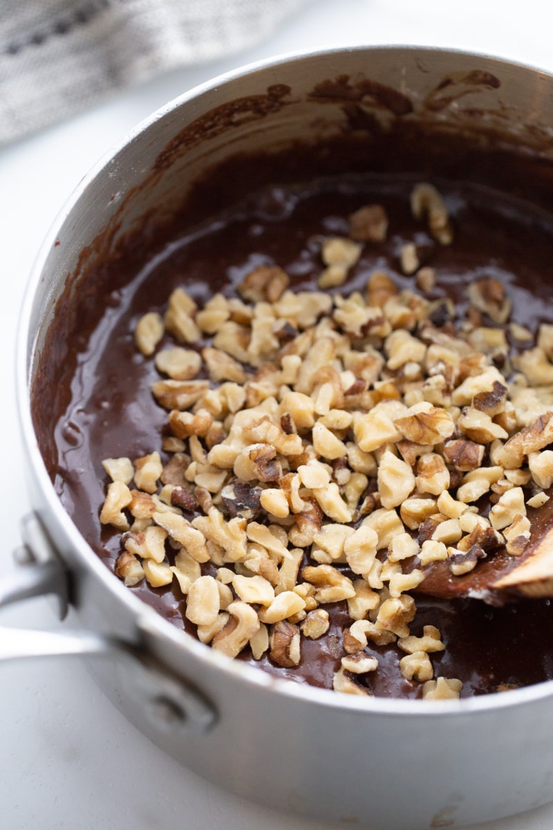 nuts added to brownie batter in saucepan
