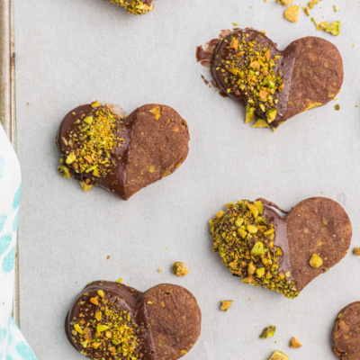 chocolate pistachio cut out cookie hearts dipped in chocolate and pistachios