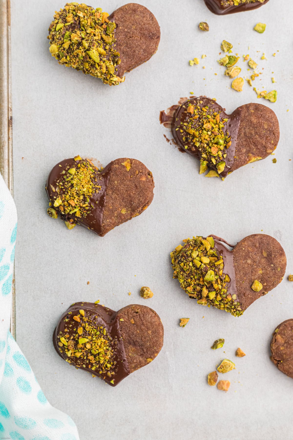 chocolate pistachio cut out cookie hearts dipped in chocolate and pistachios