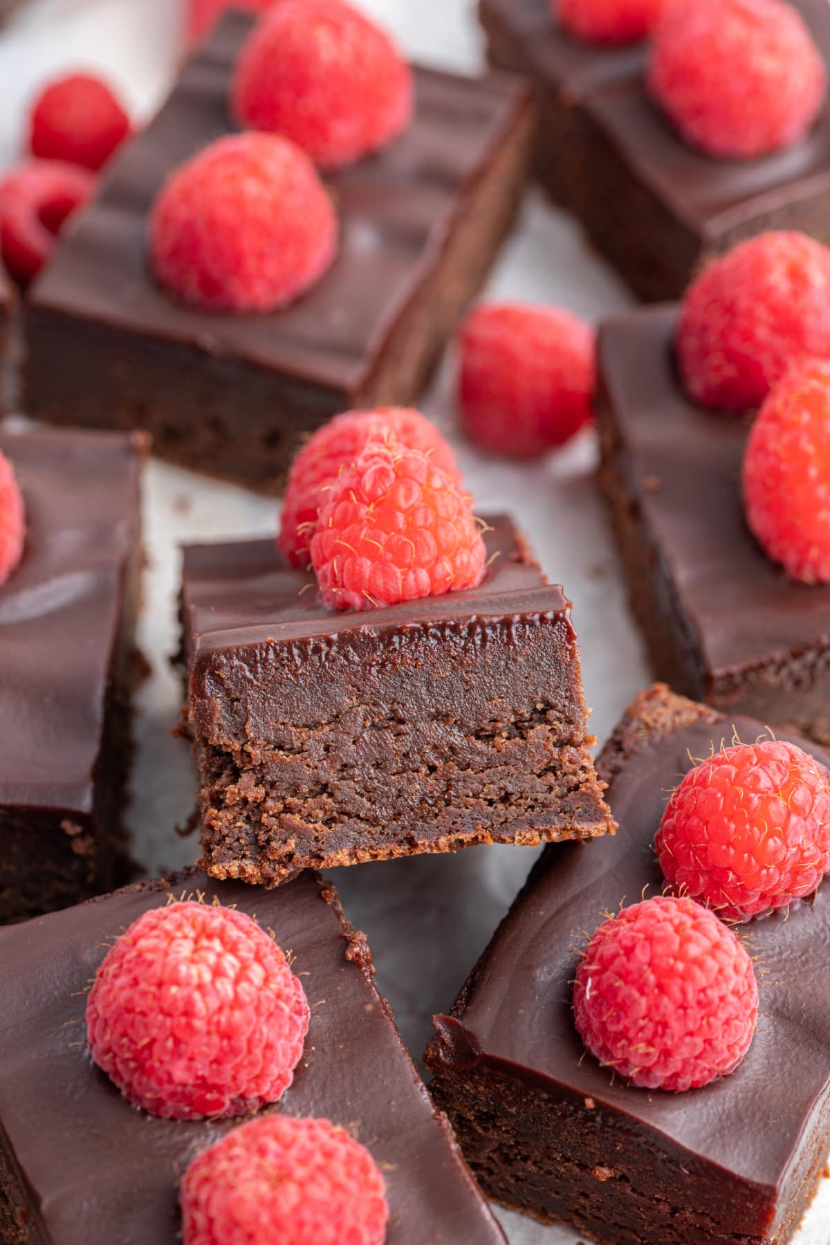 close up at the edge of a fudgy chocolate raspberry bar
