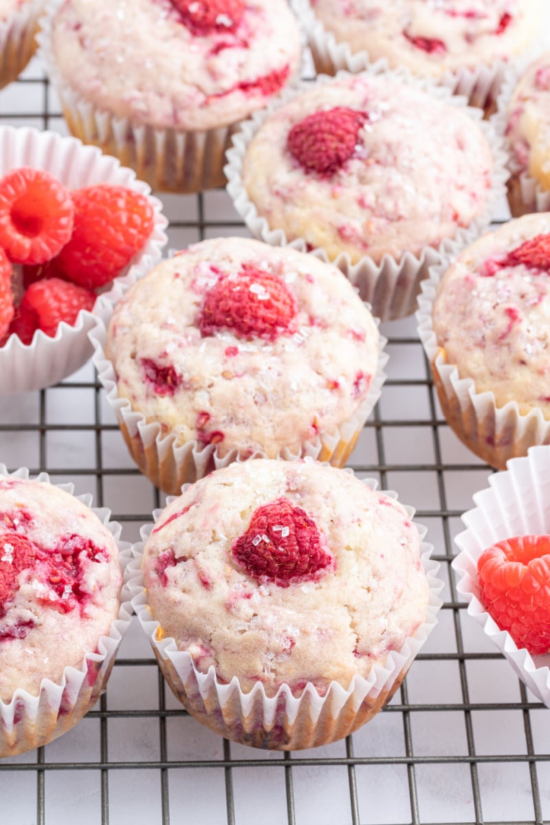 sugar crusted raspberry muffins on a cooling rack