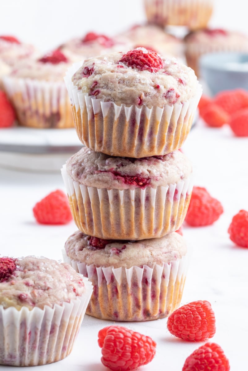 three sugar crusted raspberry muffins stacked