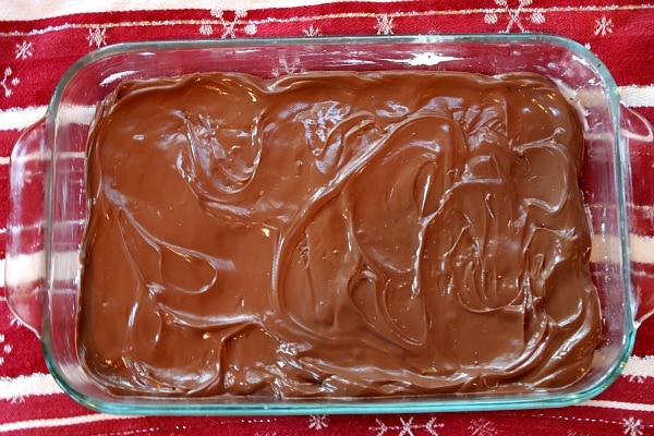 melted chocolate in a baking dish making almond roca