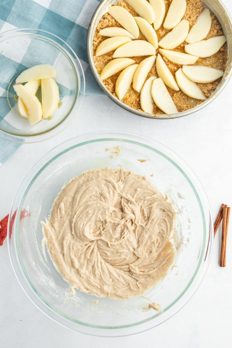 showing process of making apple upside down cake with batter and apples in pan