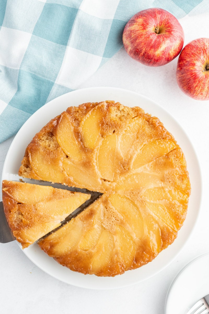 serving slice from apple cinnamon upside down cake