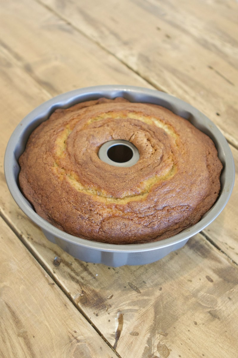 banana bundt cake in a bundt cake pan sitting on a wooden table