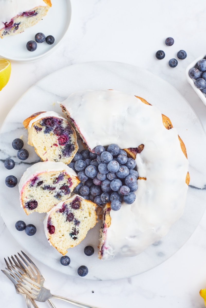 blueberry cake with lemon buttercream half sliced