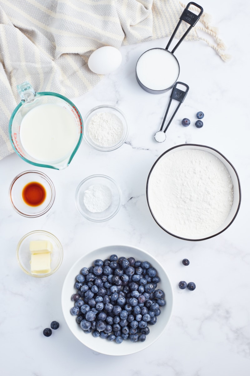 ingredients displayed for making blueberry cake with lemon buttercream