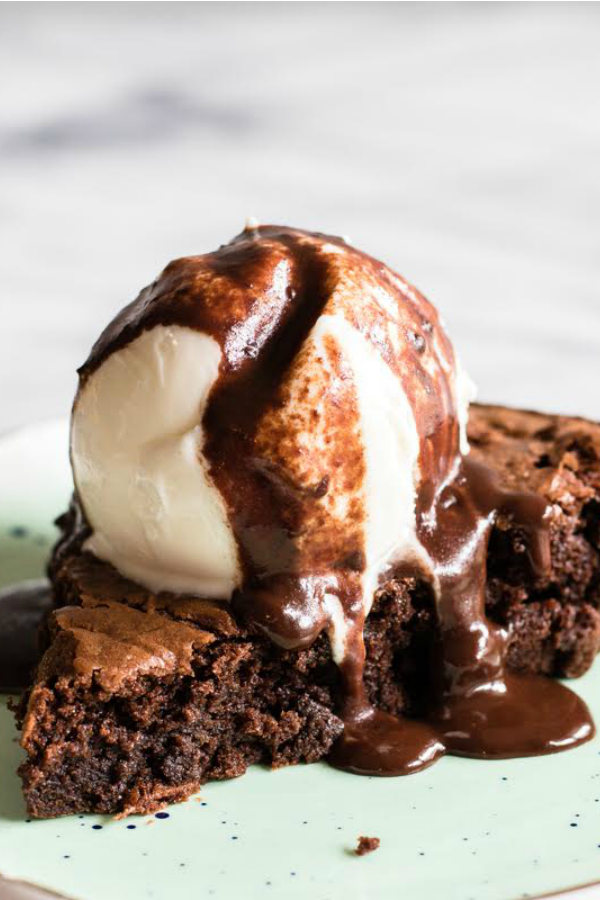 Warm Brownie Pie topped with ice cream and fudge sauce