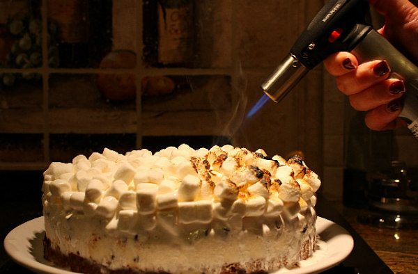 Torching the marshmallows on S'Mores Ice Cream Cake