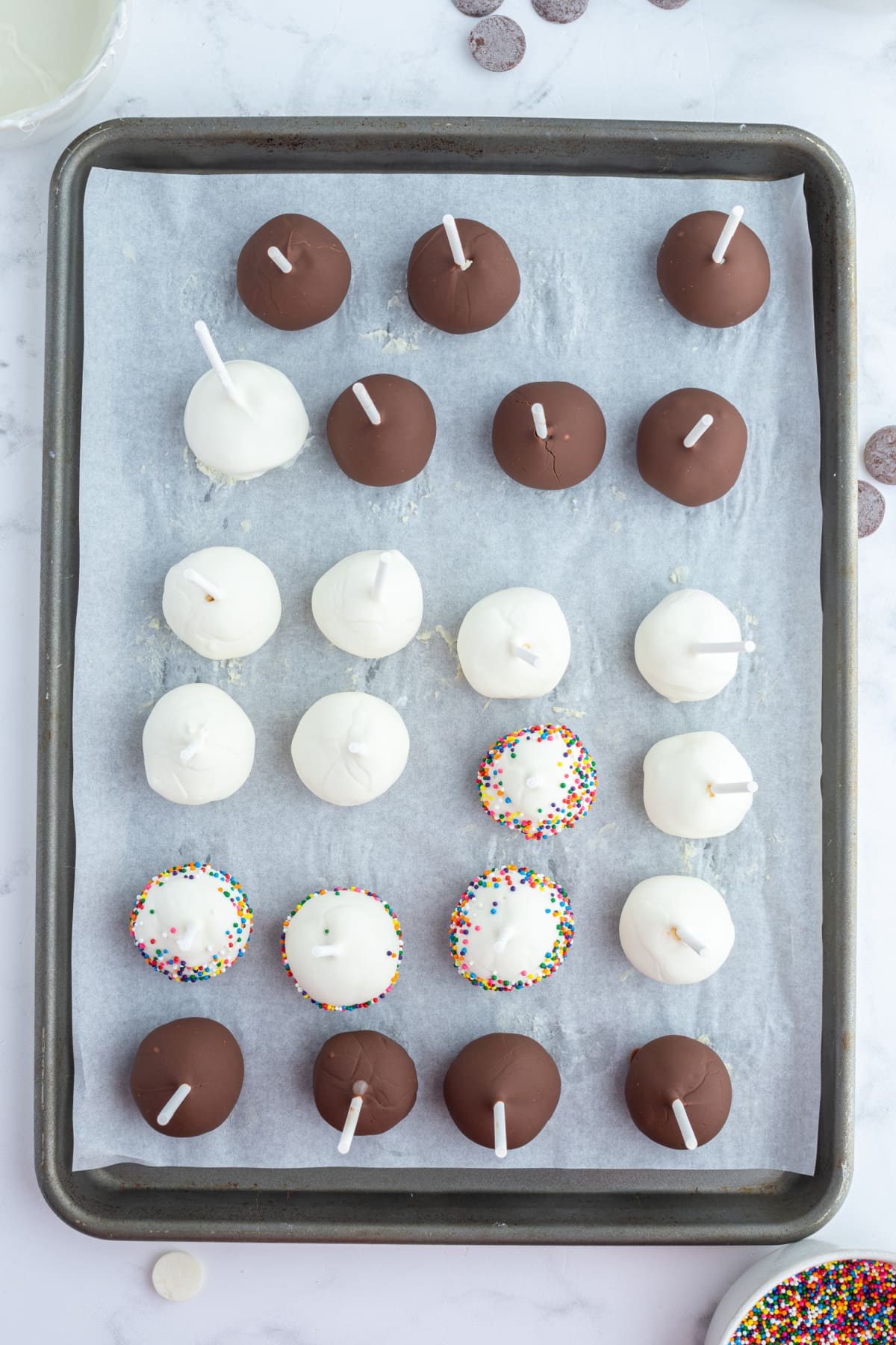 overhead shot of cheesecake pops on baking sheet