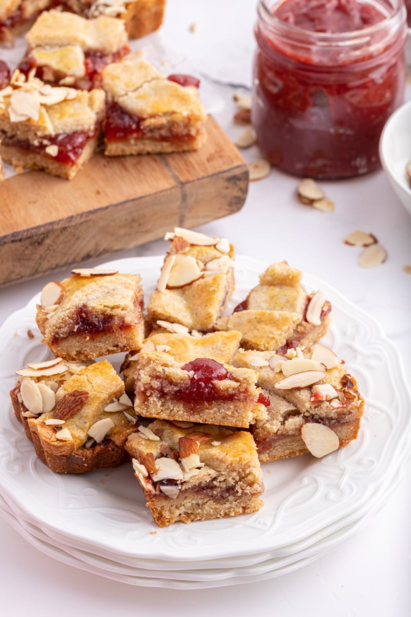 cherry almond tart cut into pieces on plate