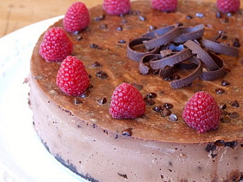 Chocolate Chocolate Chip Cheesecake garnished with raspberries