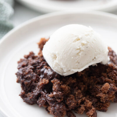 chocolate pudding cake topped with vanilla ice cream