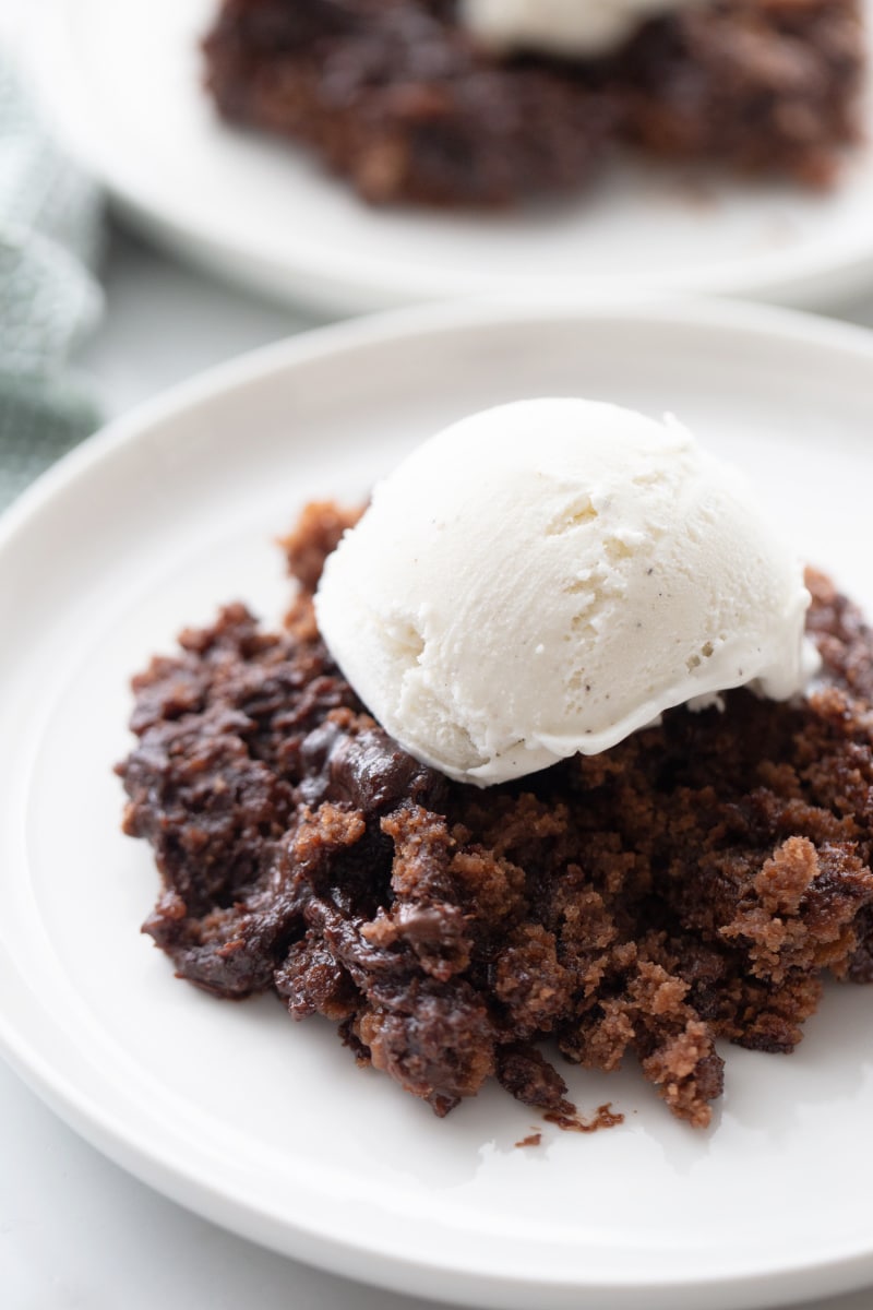 chocolate pudding cake topped with vanilla ice cream