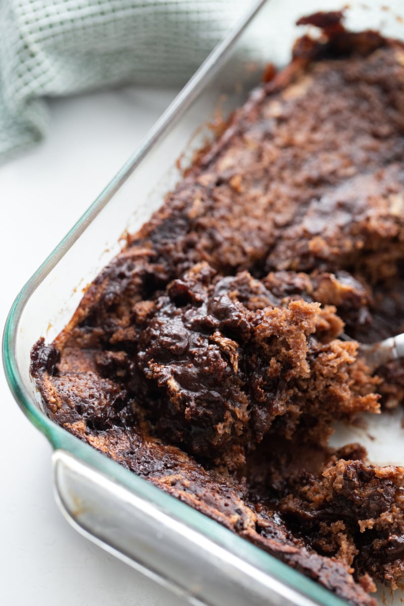 chocolate pudding cake in cake pan with spoon