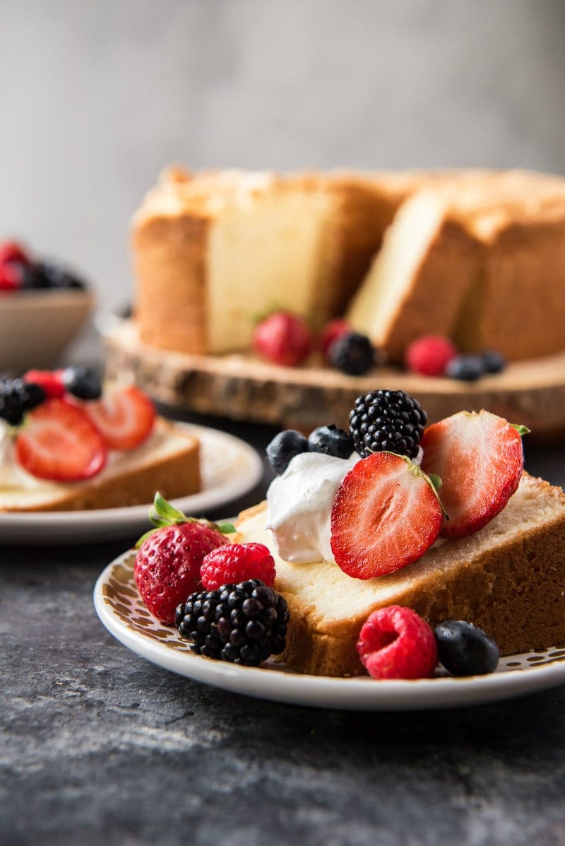 Sliced pound cake with whipped cream and berries