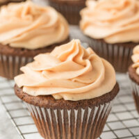 gingerbread cupcakes with pumpkin frosting on rack