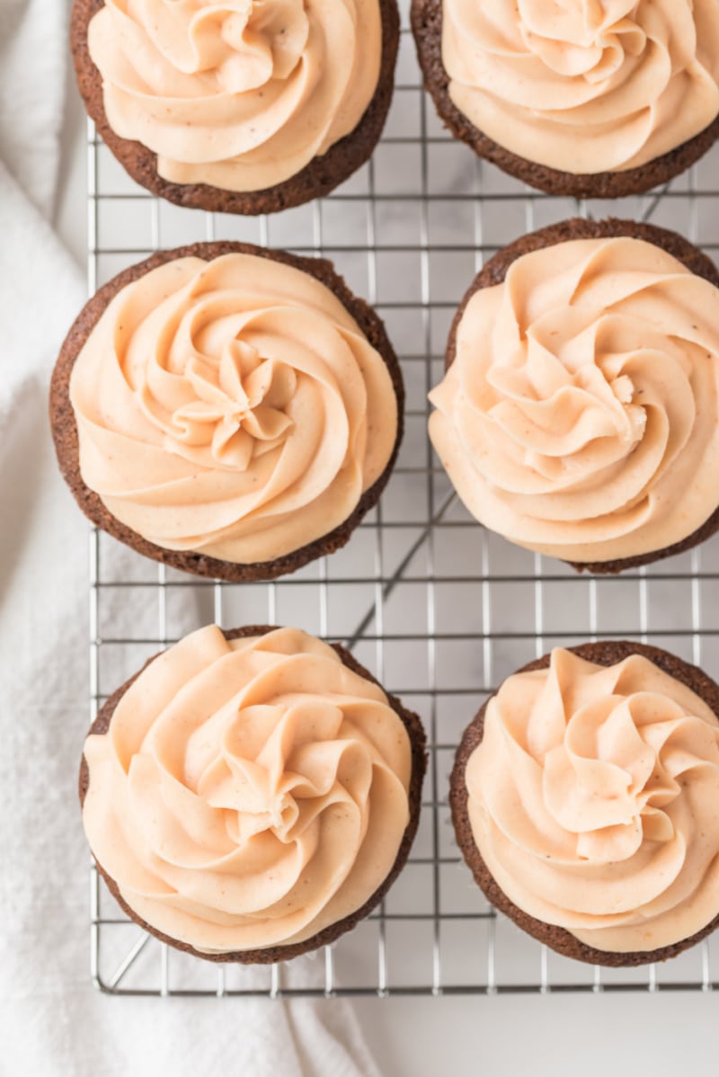 overhead shot of cupcakes with orange frosting
