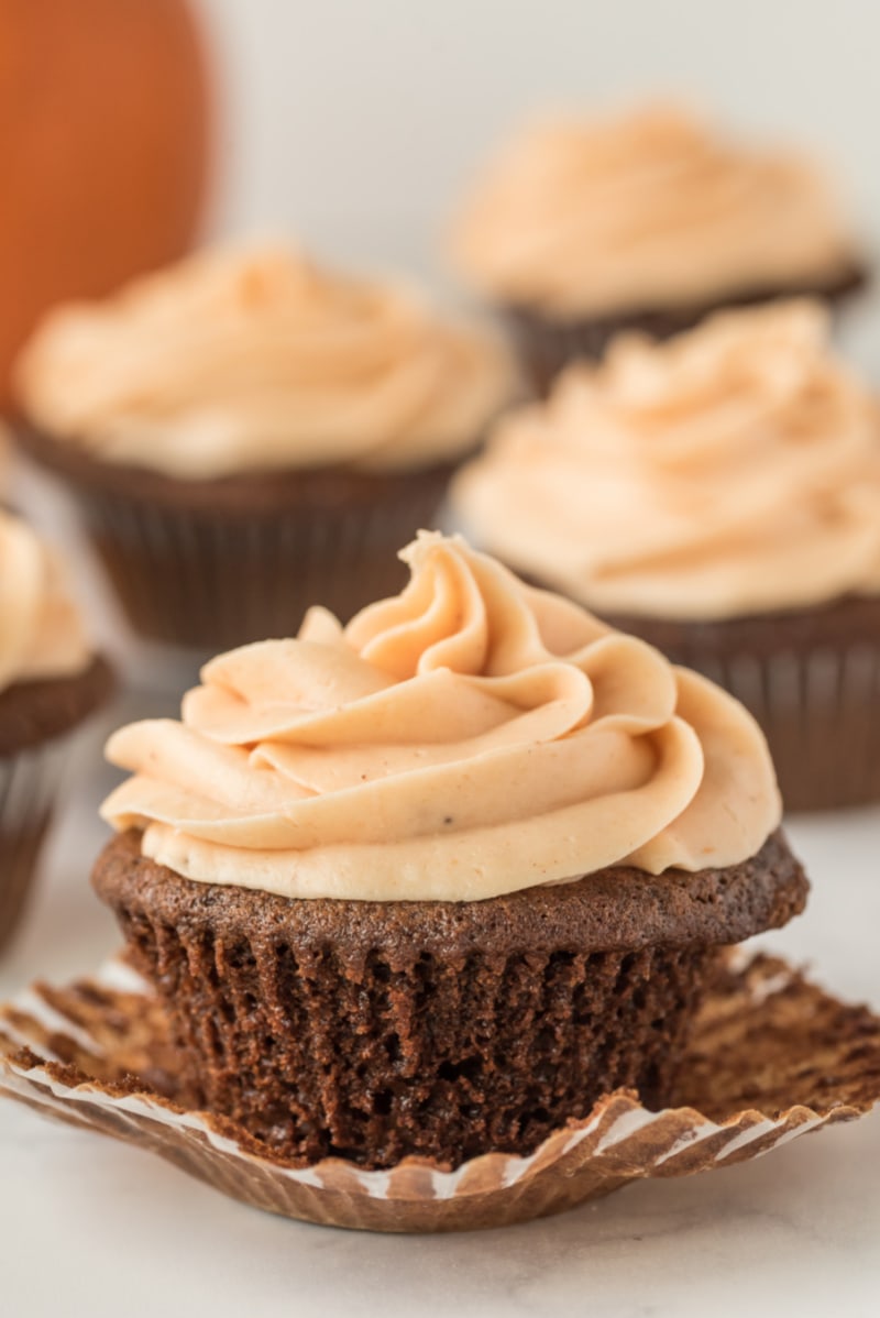 gingerbread cupcake unwrapped with pumpkin frosting