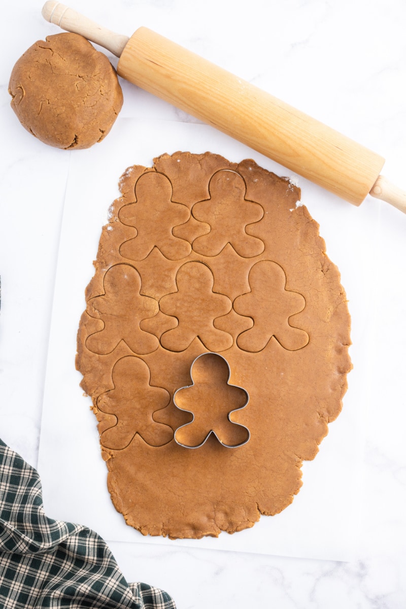 gingerbread dough rolled out and people cut out of it