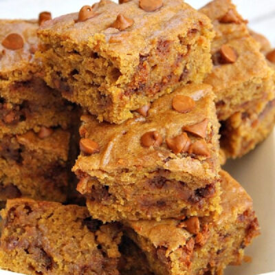 cinnamon pumpkin bars stacked on a white plate