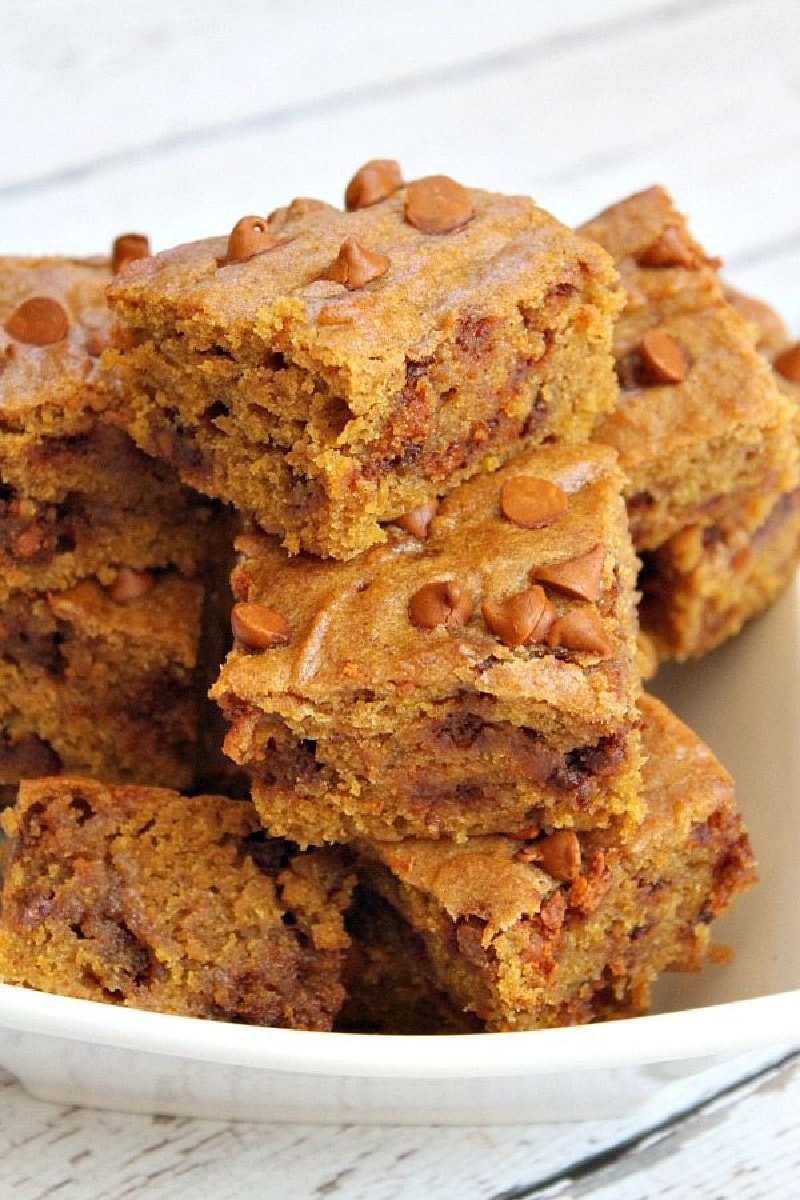 cinnamon pumpkin bars stacked on a white plate