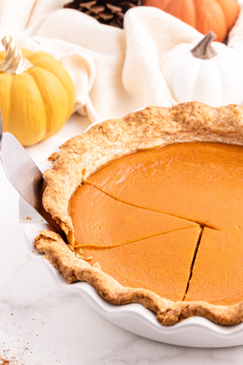 spatula taking out slices of maple pumpkin pie