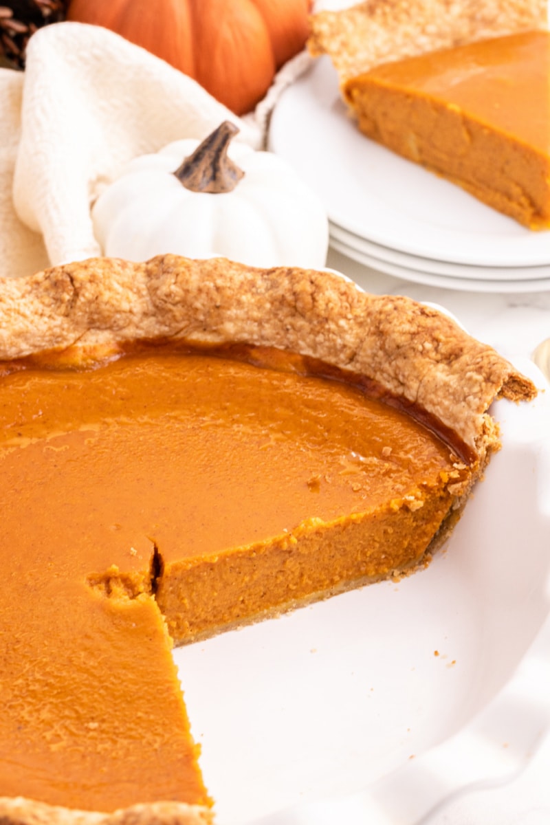 pumpkin pie with a couple slices taken out of it