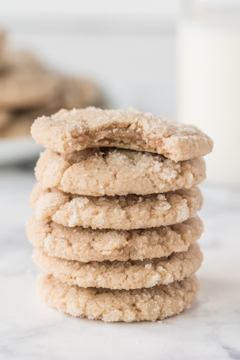 stack of cookies with one with bite out of it on top