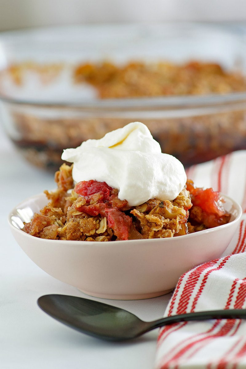 Bowl of Apple Cranberry Crisp topped with Maple Whipped Cream