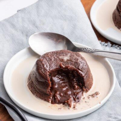 molten chocolate cake on plate cut open with chocolate inside coming out