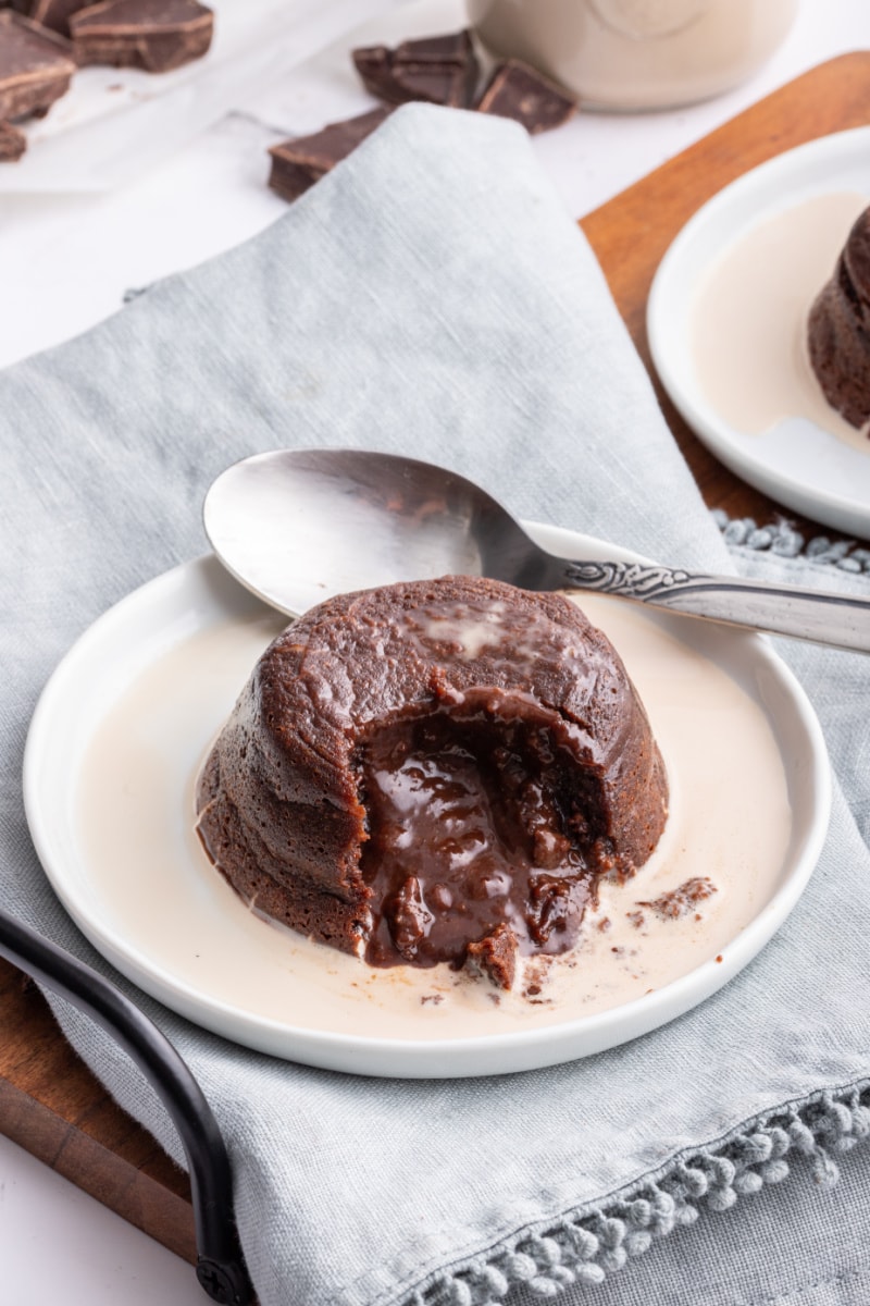 molten chocolate cake on plate cut open with chocolate inside coming out