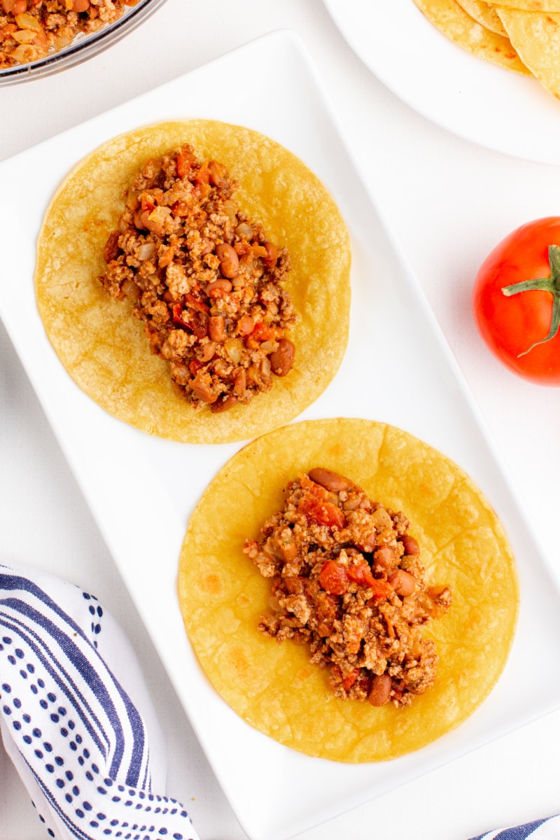 two tortillas on plate with meat on them