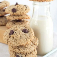 peanut butter oatmeal chocolate chunk cookies in a stack with a glass of milk