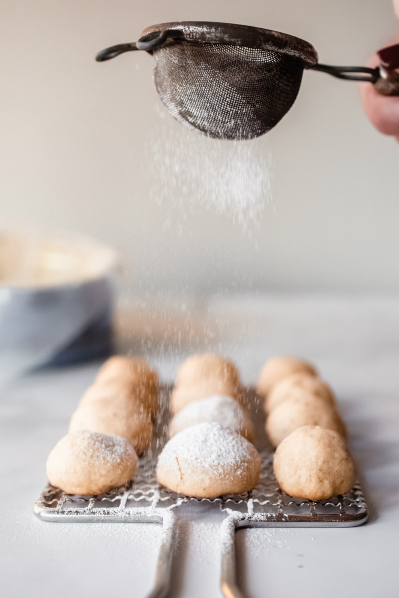 sprinkling powdered sugar on hot pecan sandies