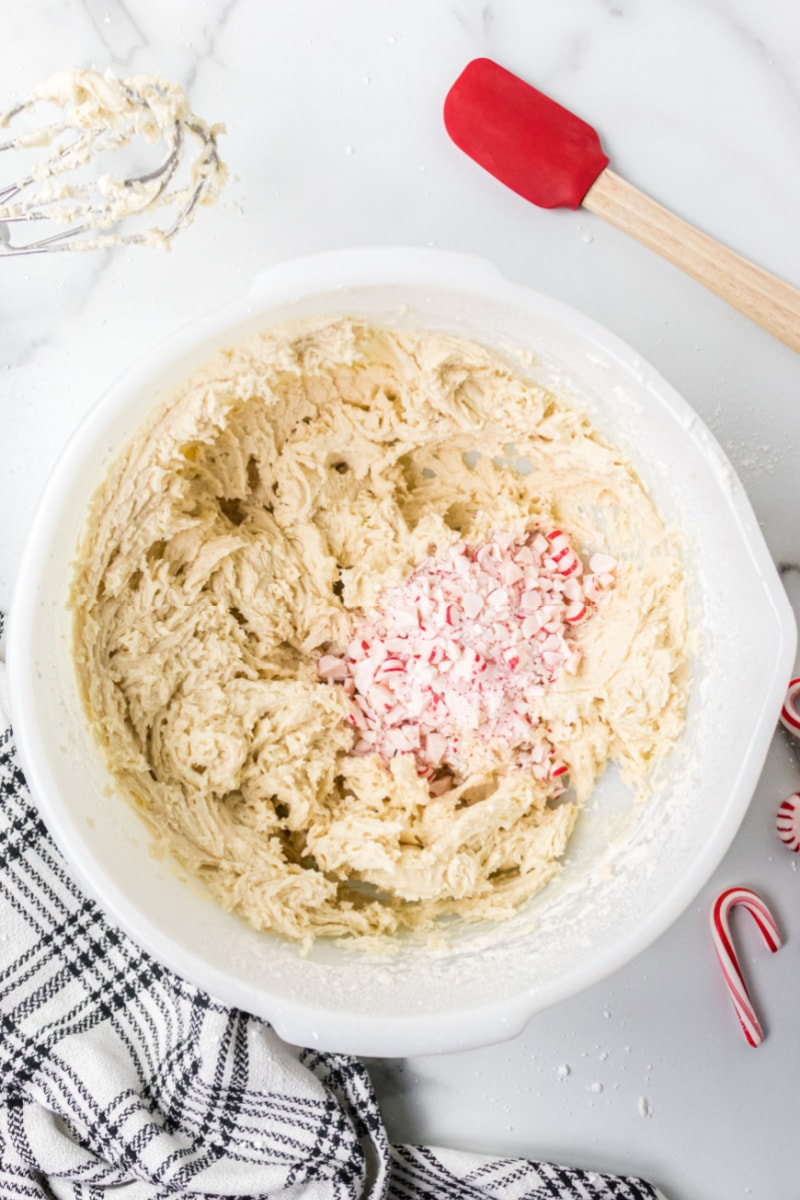 cookie dough in a bowl with added crushed candy cane