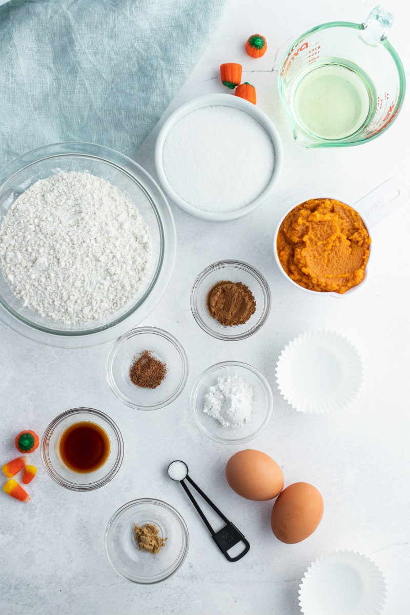 ingredients for pumpkin cupcakes displayed in bowls