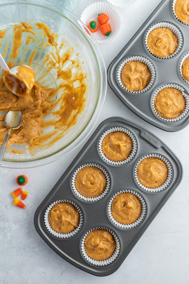 cupcake tins filled with pumpkin cupcake batter