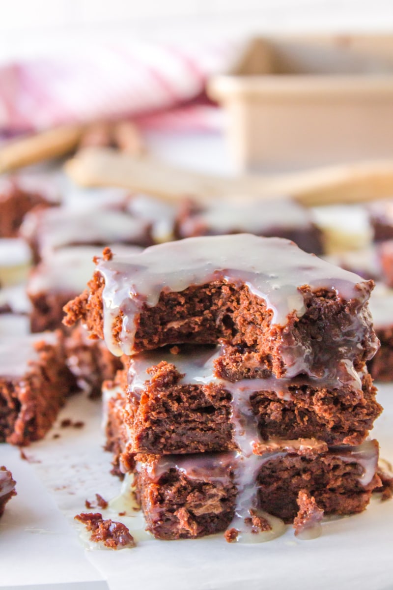 stack of three brownies one with bite taken out of it