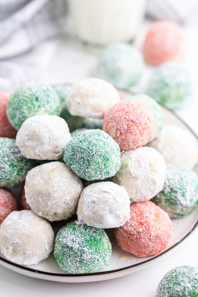 colored snowball cookies in a bowl