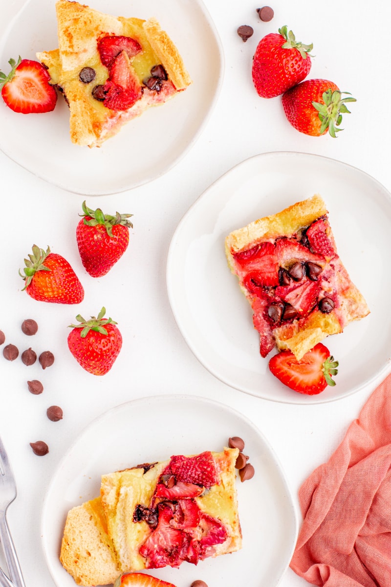 three plates of strawberry chocolate chip bread pudding